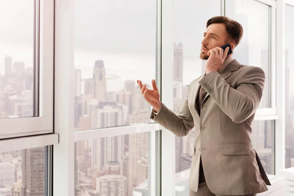 Hombre de negocios exitoso hablando en el teléfono inteligente — Foto de Stock