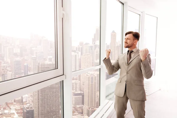 Überglücklicher Geschäftsmann steht im Büro — Stockfoto