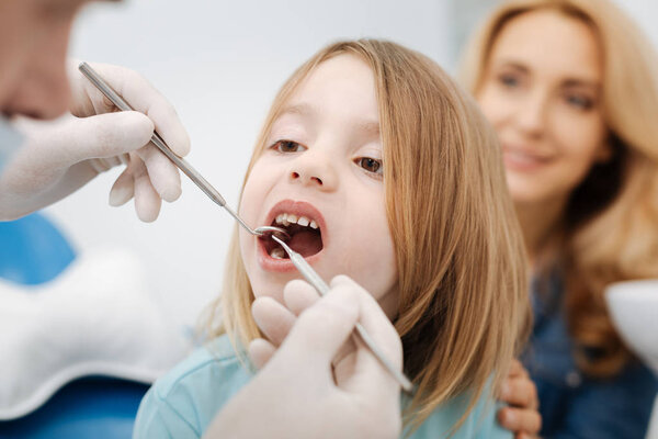 Gentle pediatric dentist doing a checkup