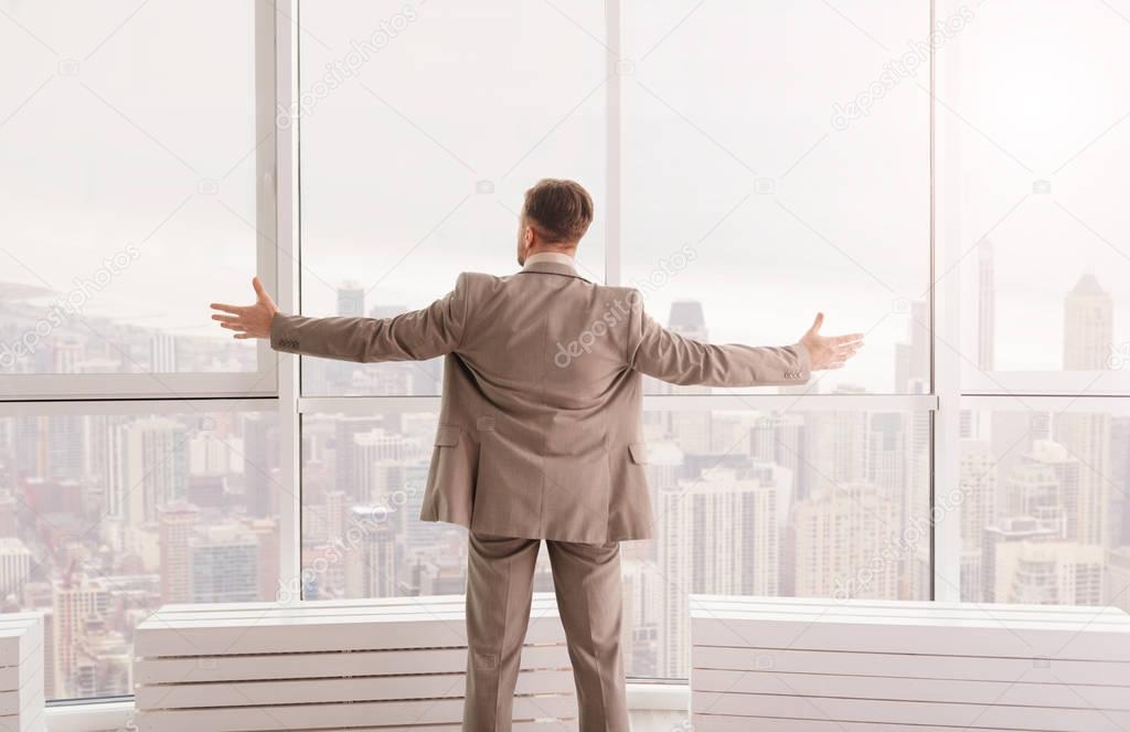 businessman enjoying the view from his office