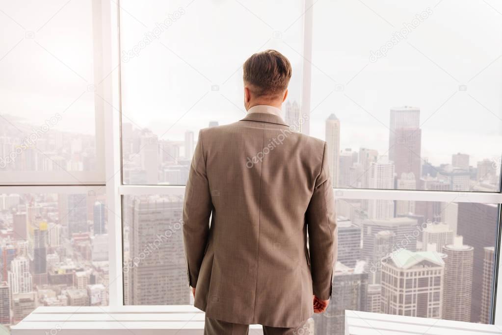 businessman standing near window