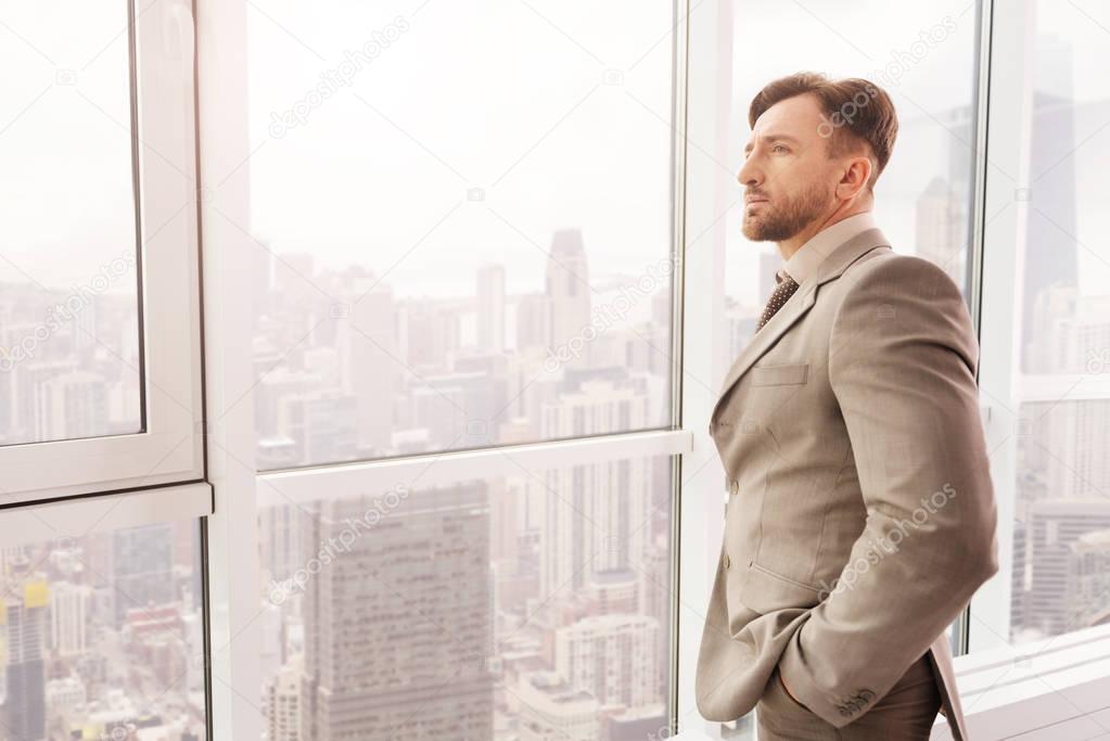 businessman standing near window 