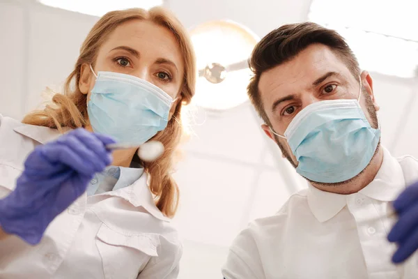 Precise competent dentists making their patients smile beautiful — Stock Photo, Image