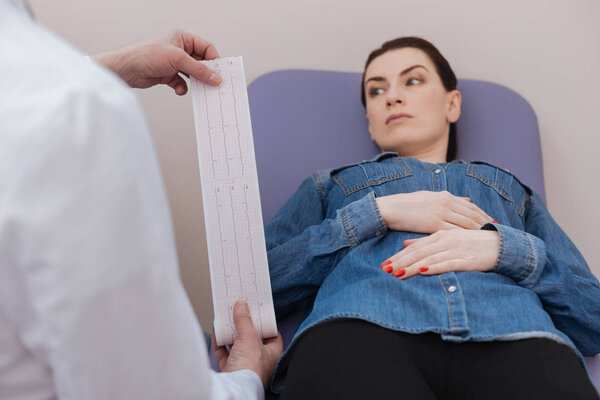 Troubled thoughtful woman waiting for doctors decision