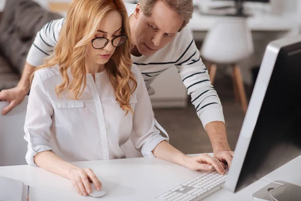 Besatt mogen boss distraherande unga sekreterare på kontoret — Stockfoto