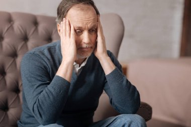 Old handsome man has terrible headache clipart