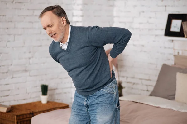 Old man standing with backache — Stock Photo, Image
