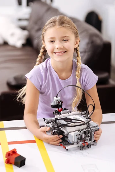 Happy pupil holding electronic robot at school — Stock Photo, Image