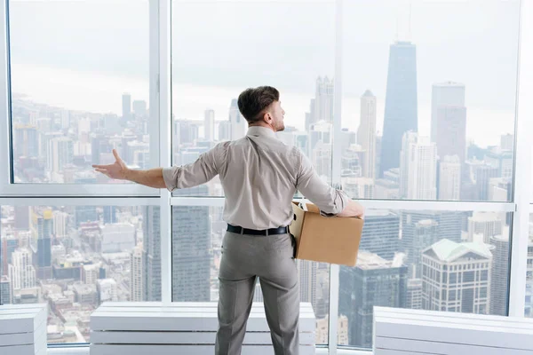 Fired businessman felling sad and carrying his belongings — Stock Photo, Image