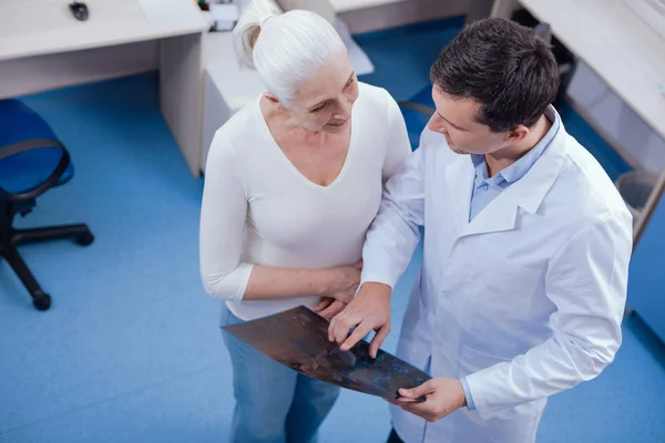 Pleasant polite doctor talking to his patient — Stock Photo, Image