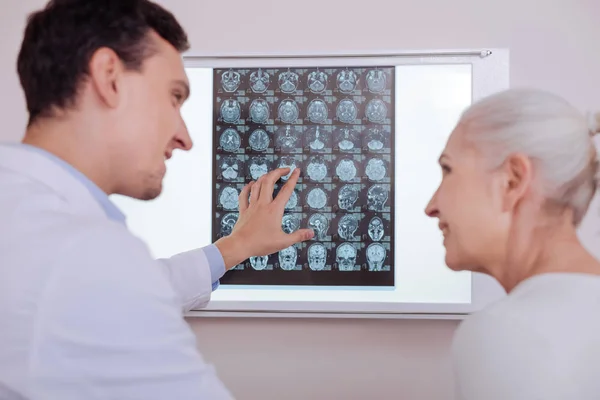 Delighted positive doctor looking at his patient — Stock Photo, Image