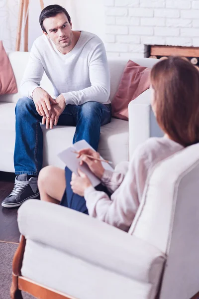 Agradable buen hombre mirando a su terapeuta — Foto de Stock