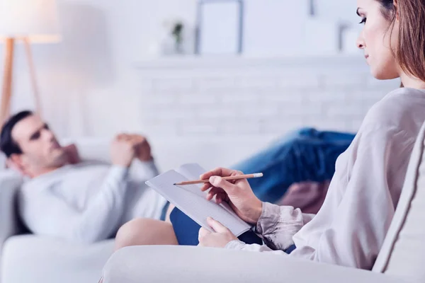 Confident professional psychologist taking notes — Stock Photo, Image