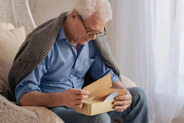 Sad nice man turning over his old letters — Stock Photo, Image
