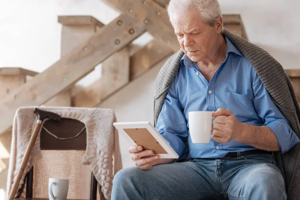 Sad grey haired man drinking tea — Stock Photo, Image