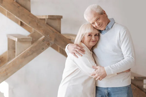 Delighted aged couple hugging each other — Stock Photo, Image