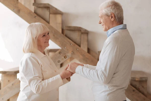 Cheerful elderly couple holding hands together — Stock Photo, Image