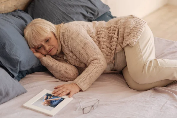 Нещаслива пригнічена жінка лежить на ліжку — стокове фото