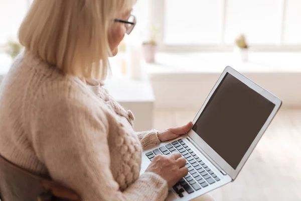 Nice grey haired woman typing — Stock Photo, Image