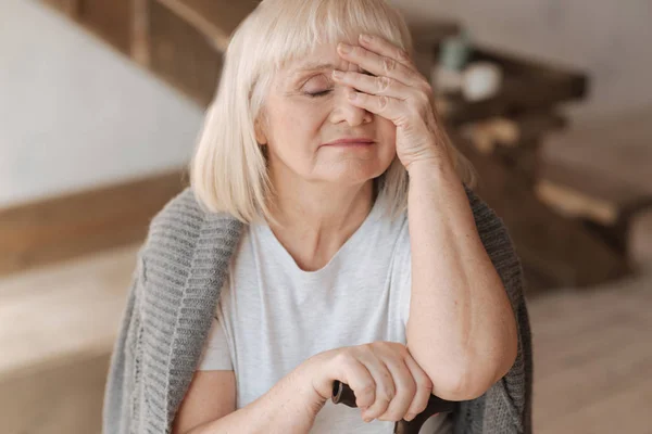 Sad elderly woman closing her eyes — Stock Photo, Image