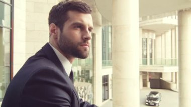 Ofis Binası yakınında duran işadamı