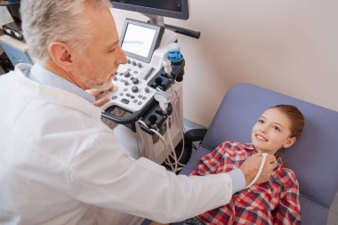 kid enjoying ultrasonic thyroid examination  clipart
