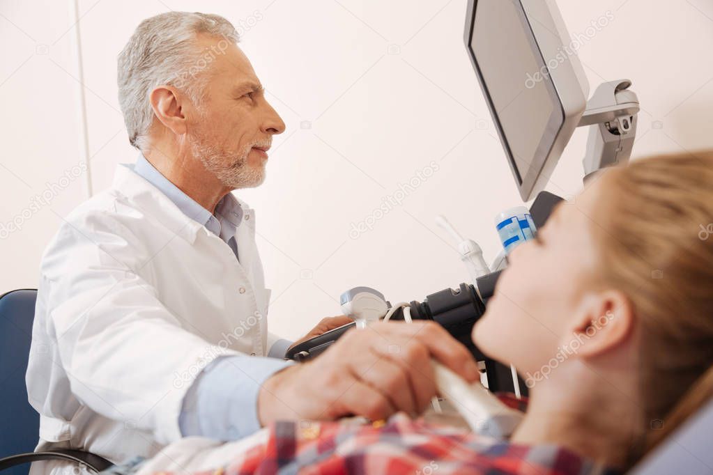 Aging physician making ultrasound monitoring 