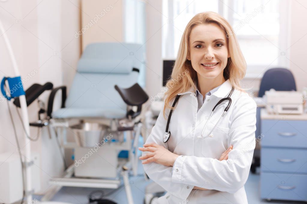 Cheerful gynecologist waiting for patient