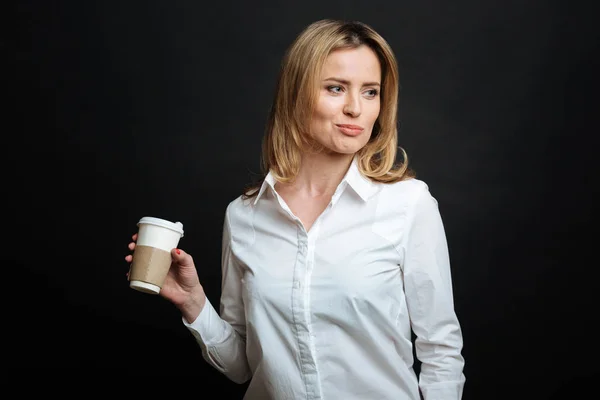 Vonzó fiatal nő élvezi a kávét a stúdióban — Stock Fotó