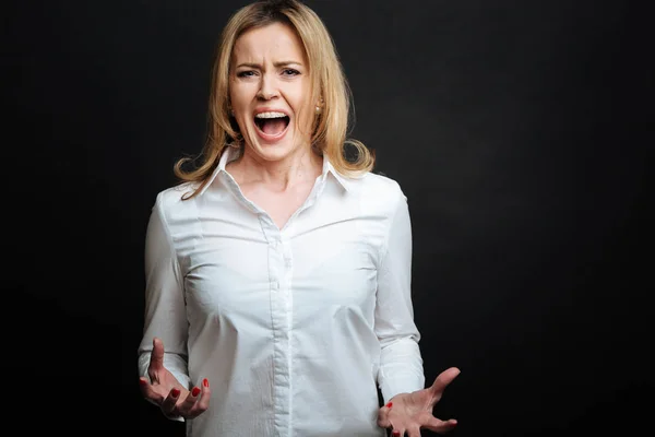 Irritated mature woman shouting in the studio — Stock Photo, Image