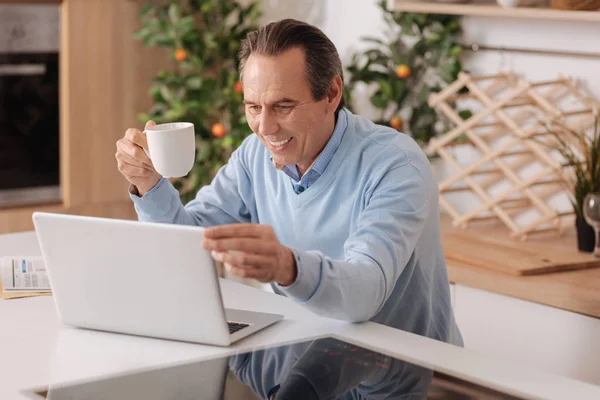 Pensionista optimista utilizando gadget moderno en casa — Foto de Stock
