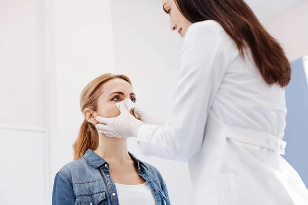 Pleasant female patient reshaping the form of her nose — Stock Photo, Image