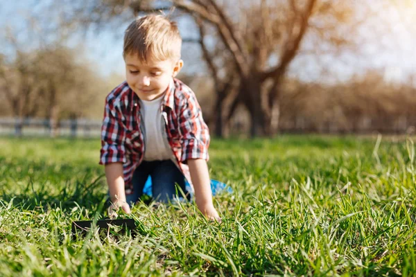 Cheerful boy crawling on hands and knees in backyard — Stock Photo, Image