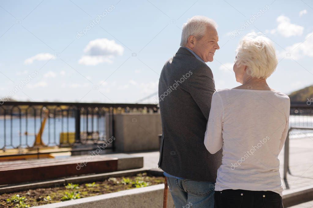 Aged husband spending time with his wife outside