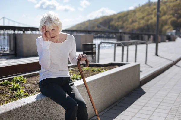 Ill pensioner having terrible pain in her head outside — Stock Photo, Image