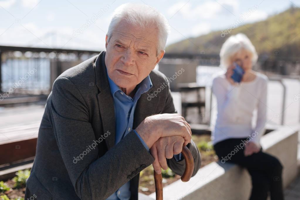 Worried man thinking about his plans on the promenade