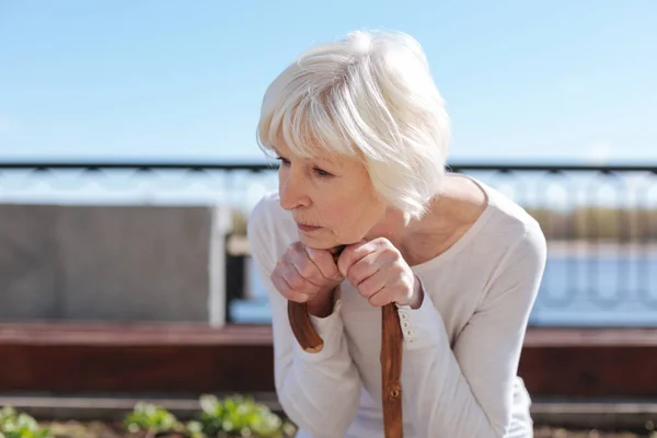 Aged lady mulling over her future near the river — Stock Photo, Image