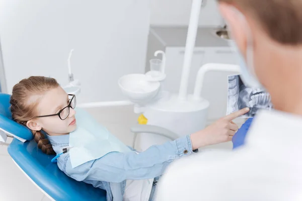 Chica entusiasta carismática haciendo algunas preguntas a su dentista — Foto de Stock