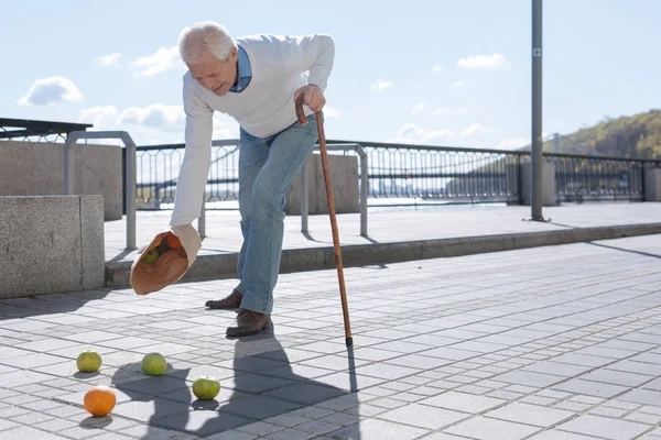 Aged man feeling pain in his arm outdoors — Stock Photo, Image