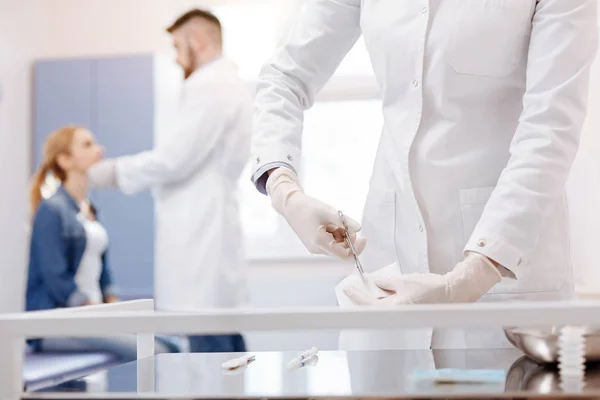 Nice professional medic holding scissors — Stock Photo, Image