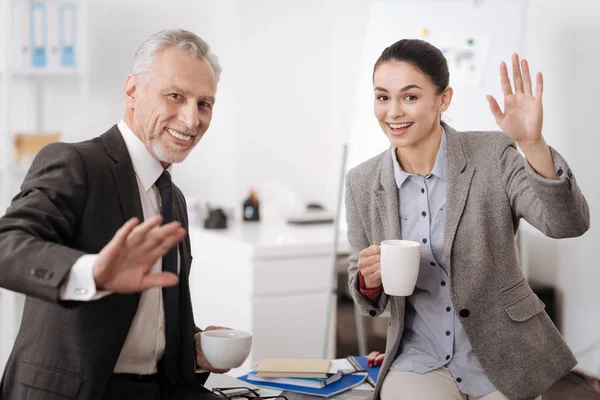 Positivos colegas encantados agitando sus manos — Foto de Stock