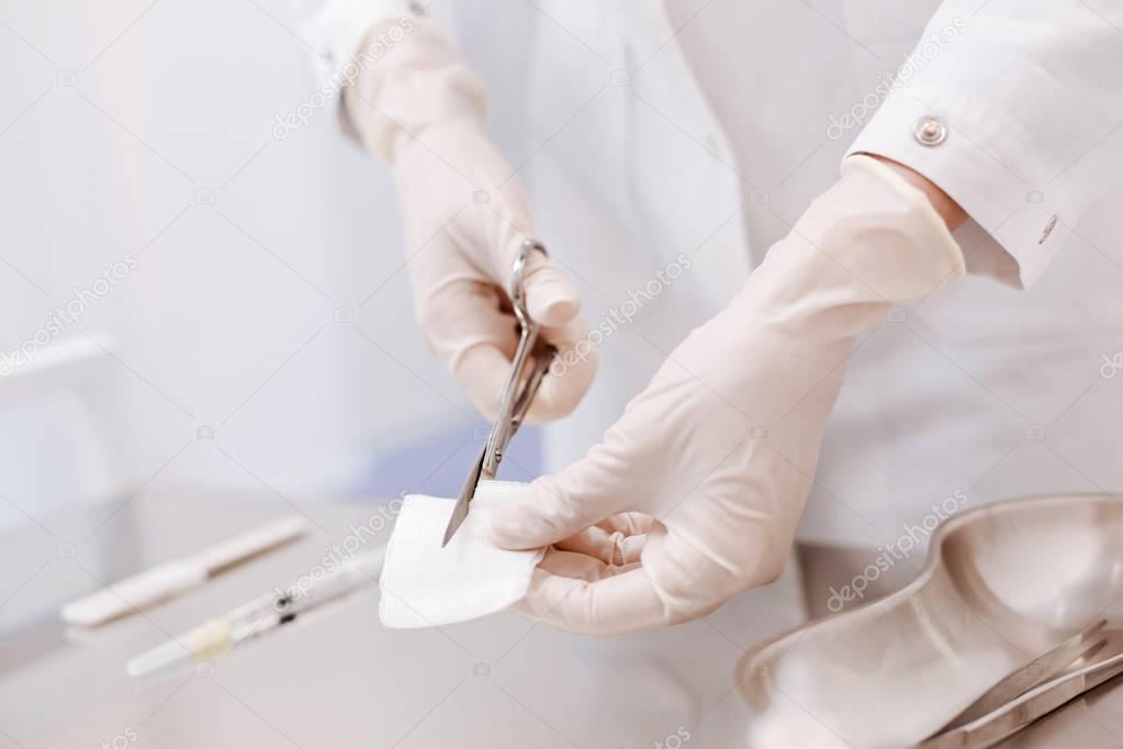 Close up of a bandage being cut into pieces