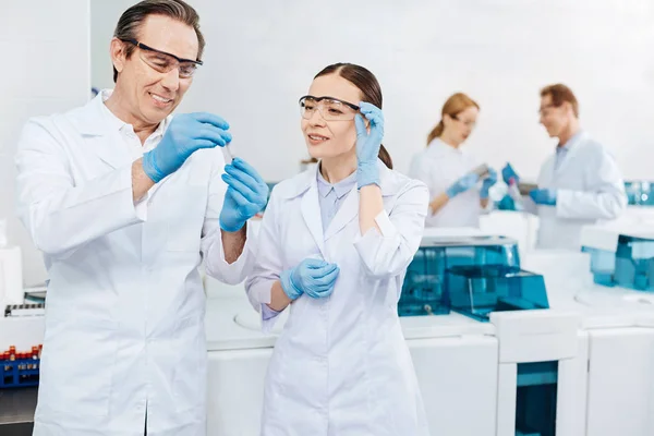 Two colleagues looking at test glass — Stock Photo, Image
