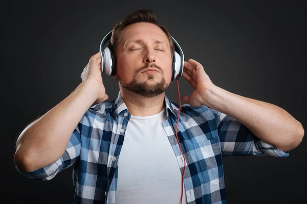 Handsome dreamy man caught in music — Stock Photo, Image