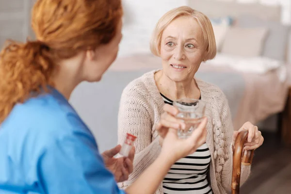 Focused mature woman taking required medication — Stock Photo, Image