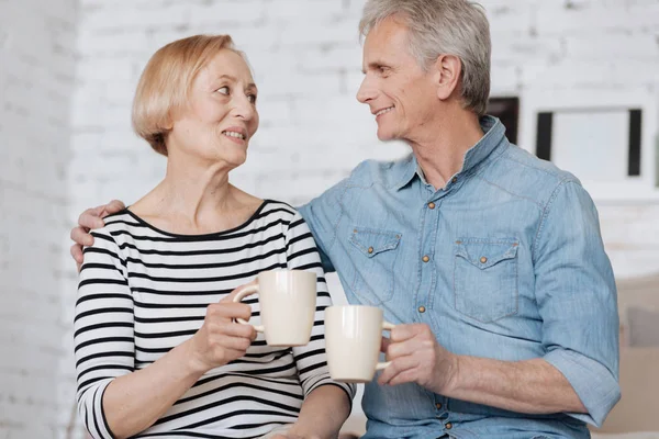 Пожилая пара наслаждается теплыми напитками — стоковое фото
