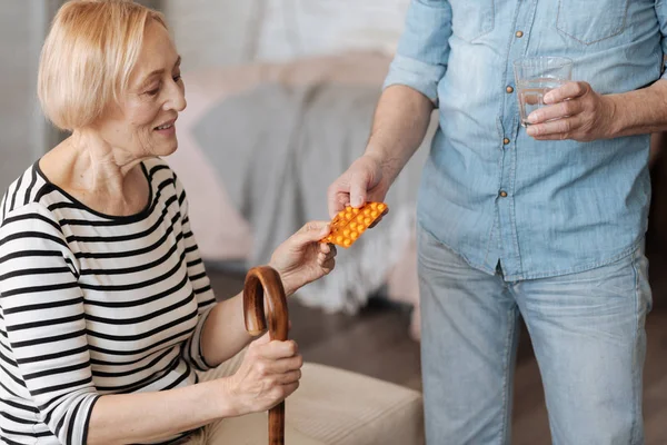 Lady having her pill served — стоковое фото