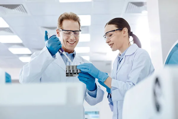 Two positive colleagues testing new material — Stock Photo, Image