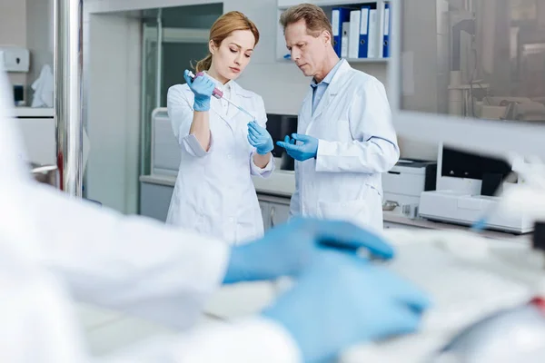 Serious medical workers standing opposite each other — Stock Photo, Image