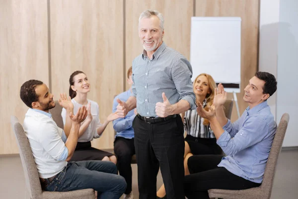 people applauding their team leader